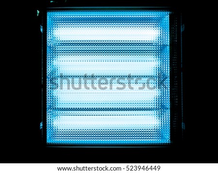 blue white square with small squares arranged in horizontal and vertical lines with gradient effect, dark grid against light lamps, close-up of movie illuminant divided into horizontal sections