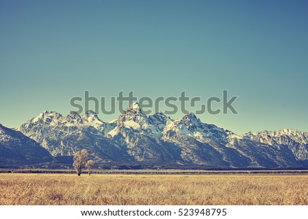 Retro toned view of Grand Teton mountain range, Wyoming, USA.