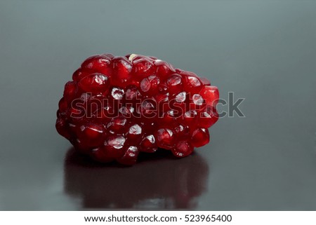 peeled pomegranate fruit on brown background