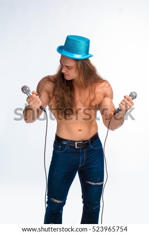 singer bodybuilder shirtless with long hair in a blue hat with a microphone on a white background