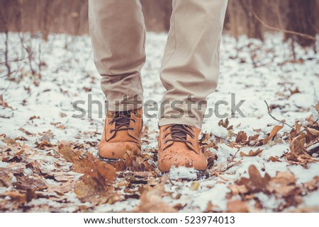 Closeup of male winter shoes on snow