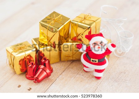 Christmas with decorate and santa claus gift boxes on wooden board.