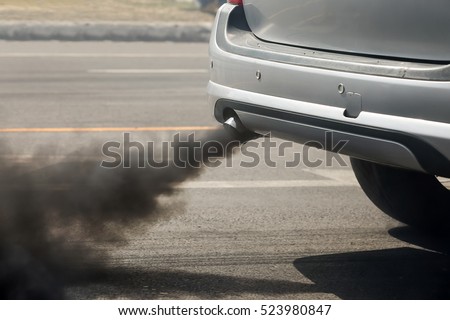 Air pollution from vehicle exhaust pipe on road Royalty-Free Stock Photo #523980847