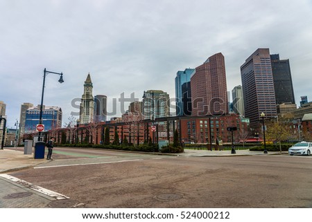 Financial District and Custom House Tower at North End Park at Cross Street in downtown Boston, Massachusetts, the US. People on the background