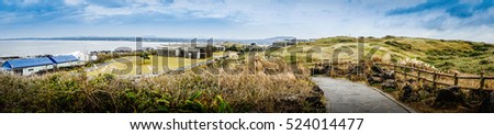 Beautiful landscape view of Seopjikoji, located at the end of the eastern shore of Jeju Island. "Seopji" is the old name for the area, and "Koji" is Jeju dialect meaning a sudden bump on land. Royalty-Free Stock Photo #524014477