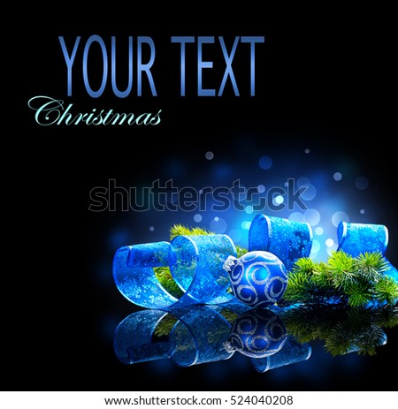 Blue Christmas and New Year Decoration isolated on black background. Border art design with holiday baubles. Beautiful Christmas tree closeup decorated with ball, ribbon, tinsel. Space for your text