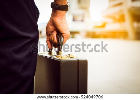 Hand's businessman carry a brief case men bag on the way to the office. Royalty-Free Stock Photo #524049706