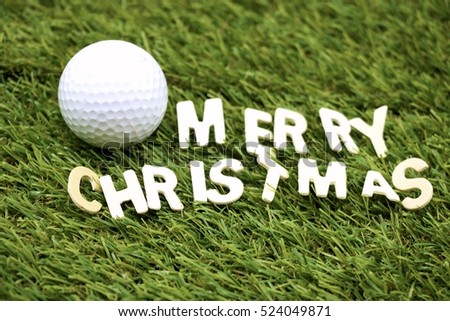Merry Christmas word  to golfer with golf ball and Christmas ornament on green course background