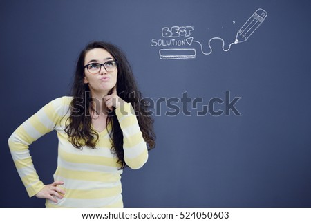 Young thinkful woman on blue gray background with finance graphs.