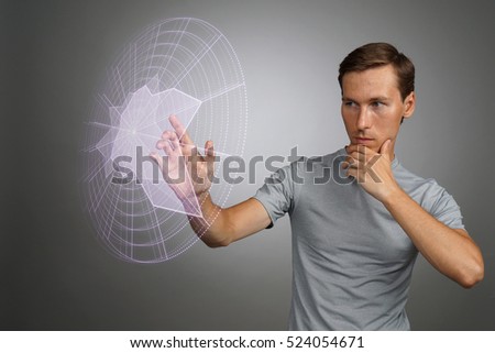 Man working with interactive Sci-Fi HUD interface.