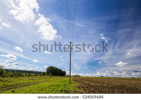 Telephone pole in the field of the Romance of automobile travel. Russia, the Ural mountains. Middle Urals.