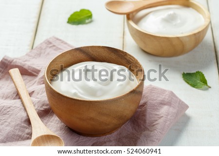 Homemade yogurt or sour cream in a wooden bowl, Health food from yogurt concept Royalty-Free Stock Photo #524060941