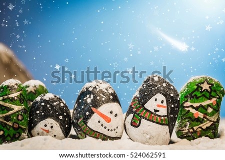 Merry Christmas and Happy New Year beautiful background. Decorated with  Christmas cartoon painting rock :  snow man, Christmas trees, gifts, star.