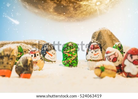 Merry Christmas and Happy New Year beautiful background.Decorated with cartoon painting rock:Santa claus,deers,snow man,Christmas trees,gifts,star and moon.Elements of this image furnished by NASA