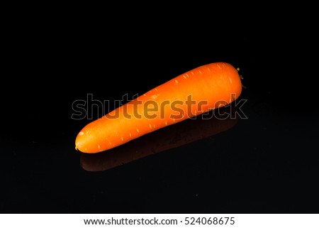 Close up Carrot on black acrylic.This is low-key photo.