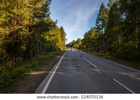 The scenery and road during the journey across Russia by car. Sunny day, the Ural mountains.