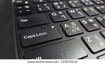 Close up key caps lock of thai keyboard of a laptop.