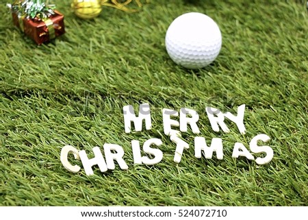 Merry Christmas to golfer with golf ball and Christmas ornament on green course background