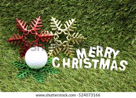 Merry Christmas to golfer with golf ball and Christmas ornament on green course background