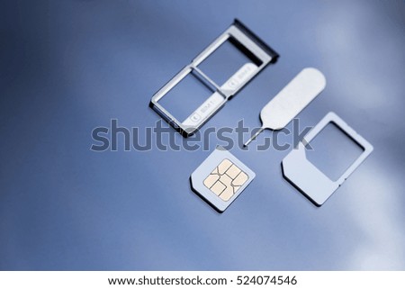 nano sim card extract from sim card adaptor and eject tool on black screen glass background