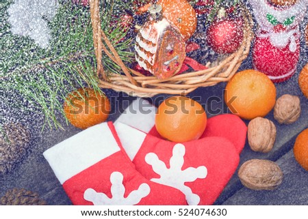 Christmas decorations lay in a wicker basket. Merry Christmas. Christmas background. Christmas Socks. 2017 year. Christmas decorations. New Year background. Xmax background. Toned image. Snow falls.