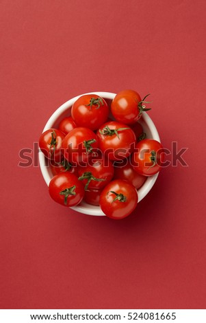 Colorful Food & drink still life concept. Color riot food photography.  Fresh fruits & vegetables on bright color background.  Red cherry tomatoes on yellow background.  Closeup. Top view.  Royalty-Free Stock Photo #524081665