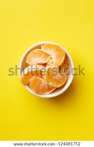 Colorful Food & drink still life concept. Color riot food photography.  Fresh fruits & vegetables on bright color background.  Orange mandarin yellow background.  Closeup. Top view. 