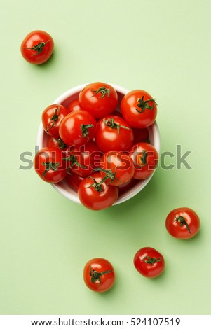 Colorful Food & drink still life concept. Color riot food photography.  Fresh fruits & vegetables on bright color background.  Red cherry tomatoes on cyan background.  Closeup. Top view.  Royalty-Free Stock Photo #524107519