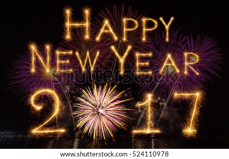 Happy new year 2017 written with Sparkle firework on fireworks with dark background, celebration and greeting cards concept Royalty-Free Stock Photo #524110978