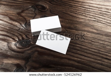 Blank business cards. Photo of blank white business cards on wooden table background. Template for ID. Mock up for branding identity. Top view.