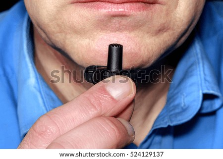 Clip microphone in the hand of man close up