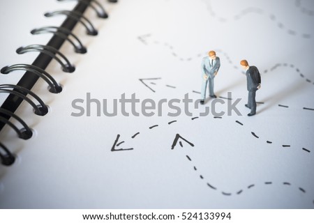 Business decision concept. Businessmen standing and giving advice with arrow pathway choice.

