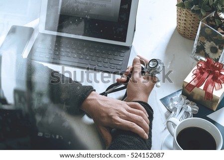 medical doctor hand with credit card and gift with laptop computer and smart phone on mable desk,icons graphic screen effect