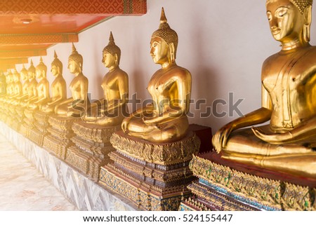 Beautiful golden Buddha, Many Buddhist statue in gold color row sitting make concentration posture to enlighten wisdom of peace to mankind in Thailand temple.