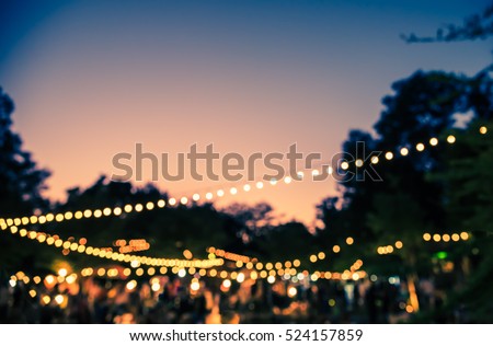 vintage tone blur image of night festival in garden with bokeh for background usage .