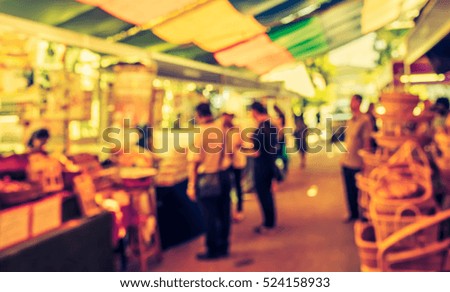 Abstract blur image of retail shop at indoor day market for background usage. (vintage tone)