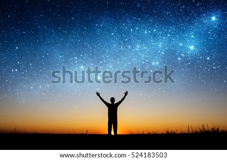 Man watching the stars. Elements of this image furnished by NASA. Royalty-Free Stock Photo #524183503