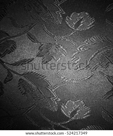 Floral fabric with a black and white vignette filter to be used as a background, overlay or texture.