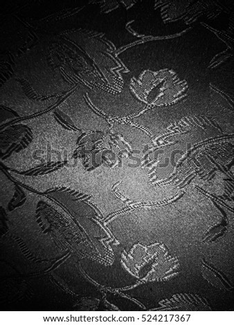 Floral fabric with a black and white vignette filter to be used as a background, overlay or texture.
