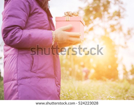 Gift is ready for you. Woman holding present.
