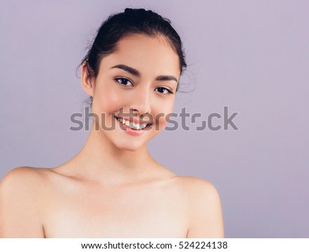 Beauty Woman face Portrait. Beautiful Spa model Girl with Perfect Fresh Clean Skin. Brunette female looking at camera and smiling. Youth and Skin Care Concept.