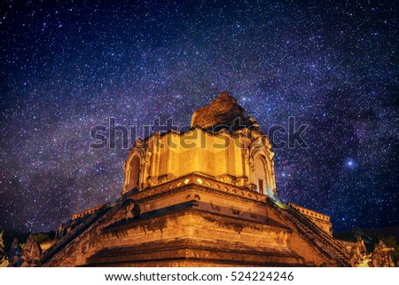 ancient pagoda Wat Chedi Luang Temple in the night with milky way in  stars field , Chiang mai , Thailand 