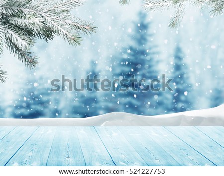 Merry christmas and happy new year greeting background with table .Winter landscape with snow and christmas trees Royalty-Free Stock Photo #524227753