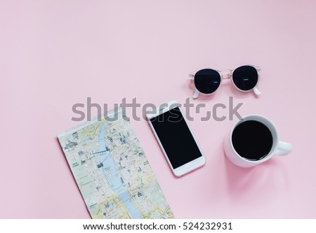 Travel planning concept : map, smartphone, sunglasses and hot coffee cup on pink background, top view with minimal style