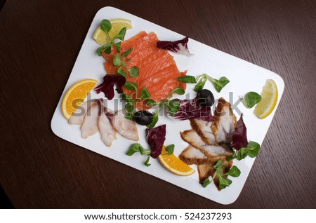 Fish snack selection on a big white plate