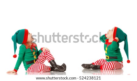 Christmas concept two children cheerful elf looking up isolated on white background