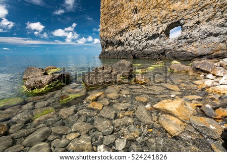 Vertical cliff with hole inside named Skala Parus on the coast of Black Sea. Gelendzhik district, Russia. Royalty-Free Stock Photo #524241826