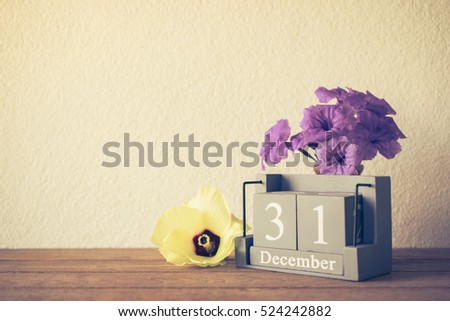 vintage wooden calendar set on the 31 of December with flower happy new year concept