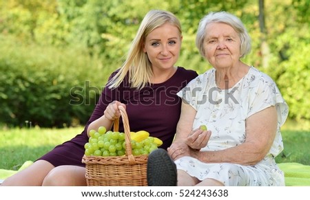 Elderly woman and young woman at the picnic.