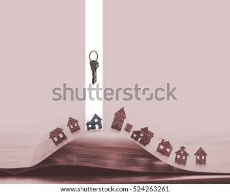 Image of a open newspaper with paper houses on red background. Above  one house stands bunch of keys. House and keys are marked in white. 